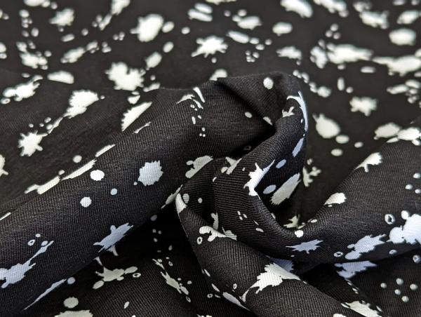 Baumwolljersey Weiße Farbkleckse auf Schwarz 35 x 150 cm